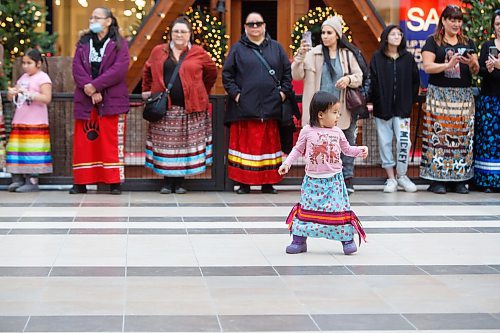 MIKE DEAL / WINNIPEG FREE PRESS
Wabigwan Greene, almost 3-yrs-old, during the first National Ribbon Skirt Day event at the Polo Park Shopping Centre on Wednesday. National Ribbon Skirt Day is held on January 4th a day where Indigenous women across the country are encouraged to wear their traditional regalia to celebrate their culture, their strength and their connection as women.
230104 - Wednesday, January 04, 2023.