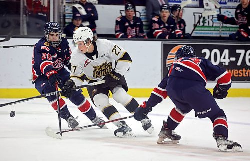 04012023
Luke Shipley #27 of the Brandon Wheat Kings plays the puck past Cole Temple #28 and Matteo Michels #34 of the Regina Pats during WHL action at Westoba Place on Wednesday evening. 
(Tim Smith/The Brandon Sun)