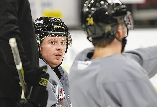Brandon Wheat Kings forward Calder Anderson watches as linemate Brett Hyland points something out at practice at Westoba Place on Thursday, with assistant coach Del Pedrick standing to his left. (Perry Bergson/The Brandon Sun)