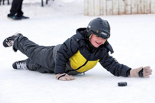 Callum Westfall-Nelson lunges to stop the puck while playing with family and friends at the Central Community Club rink in Brandon on Thursday. (Tim Smith/The Brandon Sun)