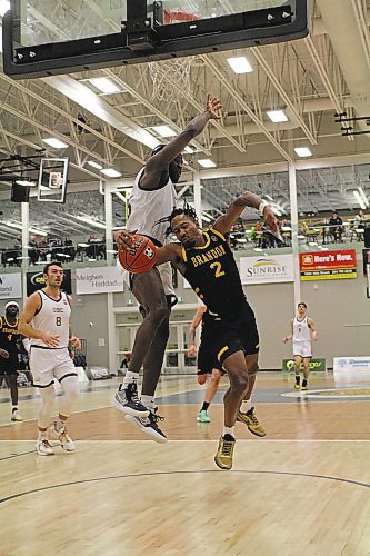 Jahmaal Gardner of the Brandon Bobcats tries to draw a foul on UBC forward Tobi Akinkunmi during their Canada West men's basketball game at the Healthy Living Centre on Saturday. (Thomas Friesen/The Brandon Sun)