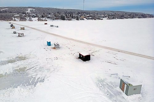 Ice-fishing shacks line the south end of Minnedosa Lake by the dam on a grey Monday. A new campaign from Travel Manitoba aims to boost tourism across the province. (Tim Smith/The Brandon Sun)