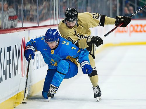 JOHN WOODS / WINNIPEG FREE PRESS
Ukraine's Yaroslav Panchenko (7) works the puck along the boards as U of MB Bisons' Tony Apetagon (20) defends during first period action in Winnipeg on Monday, January 9, 2023.