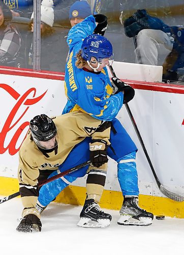 JOHN WOODS / WINNIPEG FREE PRESS
U of MB Bisons' Parker Malchuk (4) defends against Ukraine's Artem Grabovetskyi (14) during first period action in Winnipeg on Monday, January 9, 2023.