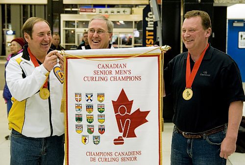 Peter Prokopowich, left, Doug Armour, and Kelly Robertson hold their banner from the 2011 Canadian senior men’s curling championship. (Winnipeg Free Press files)