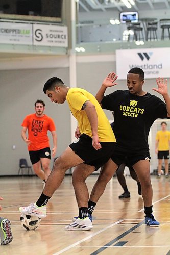 Camilo Rodriguez dribbles while Jordan Dill defends during Brandon University Bobcats men's futsal practice on Tuesday. (Thomas Friesen/The Brandon Sun)