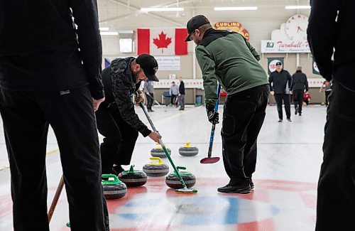 JESSICA LEE / WINNIPEG FREE PRESS

Ryan Brooks (in black) and Hartley Vanstone (in green) are photographed curling on January 12, 2023 at The Granite Curling Club.

Reporter: Taylor Allen