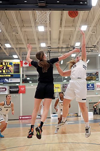 13012023
Kelsey Starchuck #15 of the Brandon University Bobcats wraps a shot on net around Emily Johnson #11 of the University of Manitoba Bisons during university basketball action at the BU Healthy Living Centre on Friday evening. (Tim Smith/The Brandon Sun)