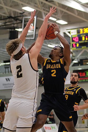 Brandon Bobcats Jahmaal Gardner shoots while Manitoba Bisons Simon Hildebrandt defends during their Canada West men's basketball game at the Healthy Living Centre on Saturday. (Thomas Friesen/The Brandon Sun)