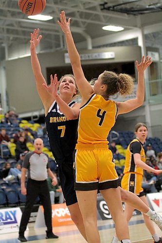 Brandon Bobcats' guard Reetta Tulkki shoots over Manitoba Bisons' Keziah Brothers during their Canada West women's basketball game at the Healthy Living Centre on Saturday. (Thomas Friesen/The Brandon Sun)