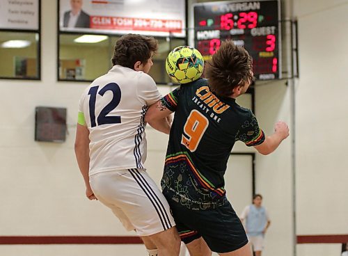 Sam Wetstein (12) of the Brandon Bobcats and Stan Pankiewicz of the CMU Blazers jump to battle for the ball during their MCAC men's futsal game at ACC on Saturday. Brandon won 7-3. (Thomas Friesen/The Brandon Sun)