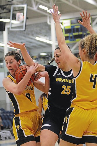 Manitoba Bisons Autumn Agar snags a rebound from Brandon Bobcats Noah Garcia during their Canada West women's basketball game at the Healthy Living Centre on Saturday. (Thomas Friesen/The Brandon Sun)