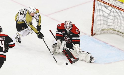 Brandon Wheat Kings forward Nate Danielson and Moose Jaw Warriors goaltender Connor Ungar try to play the puck during their Western Hockey League game at Westoba Place on Saturday. (Perry Bergson/The Brandon Sun)