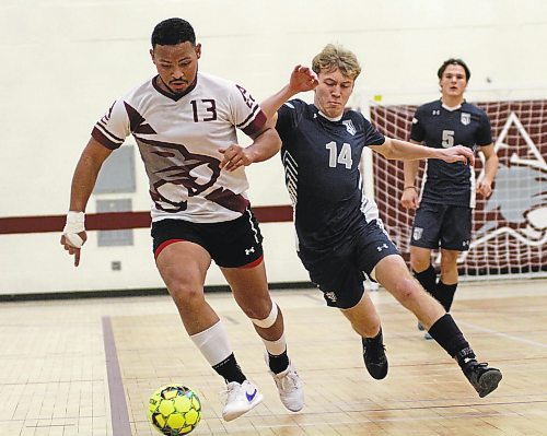 ACC Cougars' Roberto Alonzo dribbles as Providence Pilots Jordan Morello defends during their MCAC men's futsal season opener at ACC on Saturday. The Cougars won 7-3 for their first victory of 2022-23 after a winless outdoor soccer season. (Thomas Friesen/The Brandon Sun)