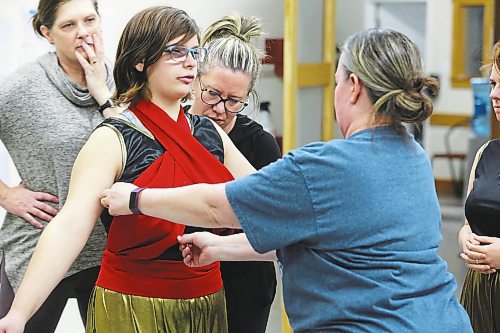 DI Productions volunteers tweak some costumes during Saturday's group rehearsal of "Aladdin Jr." at the Brandon School of Dance. (Kyle Darbyson/The Brandon Sun)