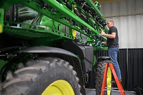 Thom Heijmans with Enns Brothers polishes a John Deere sprayer at the Keystone Centre on Monday in preparation for Manitoba Ag Days 2023, which begins today. (Photos by Tim Smith/The Brandon Sun)