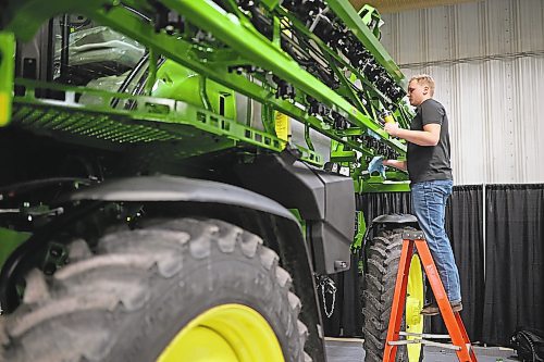 16012023
Thom Heijmans with Enns Brothers polishes a John Deere sprayer at the Keystone Centre on Monday in preparation for Manitoba Ag Days 2023, which begins today. 
(Tim Smith/The Brandon Sun)