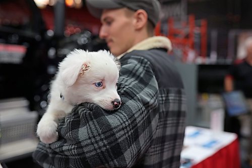 Mats Motzfeldt of Rivers holds his 10-week-old Australian shepherd Diesel while exploring Manitoba Ag Days at the Keystone Centre on Tuesday. (Tim Smith/The Brandon Sun)