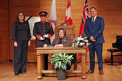 Manitoba Lt.-Gov. Anita Neville (sitting) awards a Queen Elizabeth II Platinum Jubilee medal to Amanda Conway along with Premier Heather Stefanson (far left) and MLA Cliff Cullen (right) at the Brandon University Lorne Watson Recital Hall on Tuesday. Eighty Westman individuals received medals during the ceremony. (Tim Smith/The Brandon Sun)