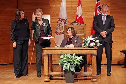 Rita Cullen makes a joke as Manitoba Premier Heather Stefanson (far left), Lt.-Gov. Anita Neville (sitting) and MLA Reg Helwer (right) react, after Cullen was awarded a Queen Elizabeth II Platinum Jubilee medal at the Brandon University Lorne Watson Recital Hall on Tuesday. Eighty Westman individuals received medals during the ceremony. (Tim Smith/The Brandon Sun)