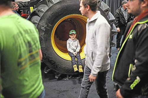 17012023
Five-year-old Jackson Siemens of Morris, Manitoba sits in the tire well of a Versatile tractor during Manitoba Ag Days 2023 at The Keystone Centre on Tuesday.  (Tim Smith/The Brandon Sun)