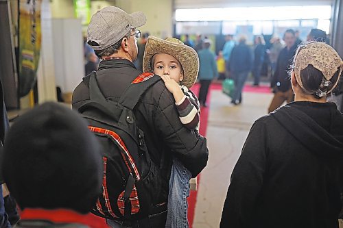 17012023
Three-year-old Nathan Friesen looks out from his dad Richard&#x2019;s shoulder while being carried through exhibits as the Friesen&#x2019;s take in Manitoba Ag Days 2023 at The Keystone Centre on Tuesday.  (Tim Smith/The Brandon Sun)