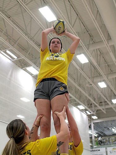 Alissa Hersey catches a lineout as teammates hoist her into the air at Bobcats women's rugby practice at the Healthy Living Centre on Monday. (Thomas Friesen/The Brandon Sun)