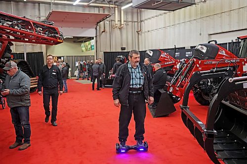 17012023
Brian Waldner of Trileaf Hutterite Colony cruises around Manitoba Ag Days 2023 on a Hoverboard at The Keystone Centre on Tuesday.  (Tim Smith/The Brandon Sun)