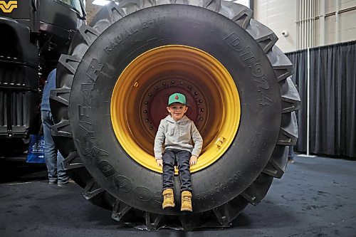 17012023
Five-year-old Jackson Siemens of Morris, Manitoba sits in the tire well of a Versatile tractor during Manitoba Ag Days 2023 at The Keystone Centre on Tuesday.  (Tim Smith/The Brandon Sun)