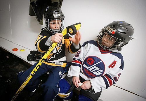 JOHN WOODS / WINNIPEG FREE PRESS
Cade, 8, and Olin Andrew, 7, right, tape their sticks before they hit the ice for hockey practice at Deer Lodge Community Centre Tuesday, January 17, 2023. 

Re: sanderson