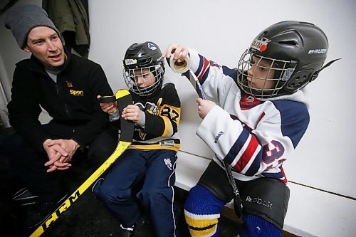 JOHN WOODS / WINNIPEG FREE PRESS
Evan Andrew looks on as his sons Cade, 8, and Olin, 7, right, tape their sticks before they hit the ice for hockey practice at Deer Lodge Community Centre Tuesday, January 17, 2023. 

Re: sanderson