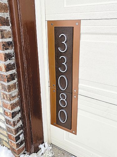Photos by Marc LaBossiere / Winnipeg Free Press
Custom decorative house numbers are mounted to the overhead door to hide damage to two of the door panels.
