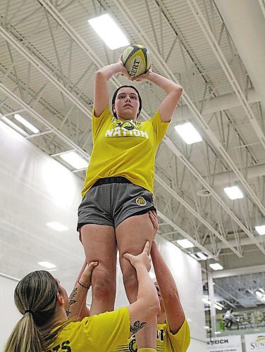 Alissa Hersey catches a lineout as teammates hoist her into the air at Bobcats women's rugby practice at the Healthy Living Centre on Monday. (Thomas Friesen/The Brandon Sun)