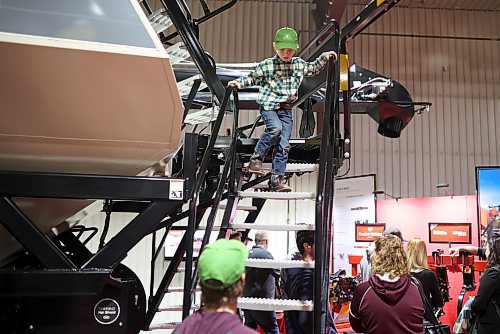 18012023
Six-year-old Wyatt Whitmer climbs down the stairs of a large farm implement while exploring Manitoba Ag Days 2023 at the Keystone Centre on Wednesday.  (Tim Smith/The Brandon Sun)