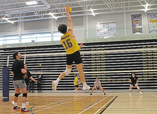 Paycen Warkentin attacks while setter JJ Love looks on during Brandon University Bobcats men's volleyball practice at the Healthy Living Centre on Wednesday. (Thomas Friesen/The Brandon Sun)