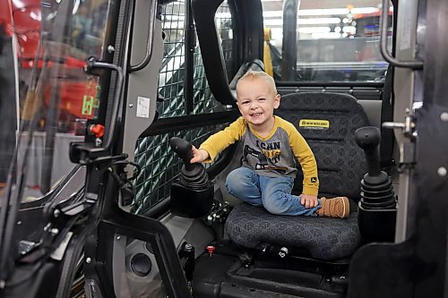 Liam Klassen, 2, plays in the cab of a front-end loader while exploring Manitoba Ag Days with his parents Bobby and Vanessa on Thursday. (Tim Smith/The Brandon Sun)