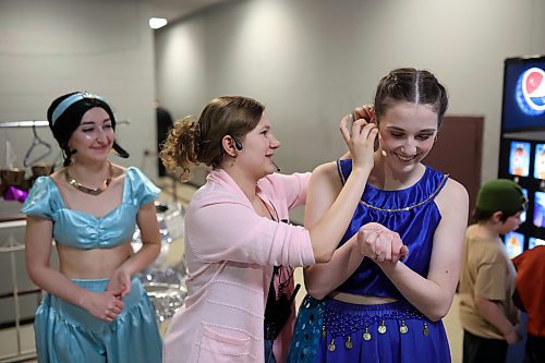 19012023
Mic tech Ava Acevedo helps Amelia Hebert with her mic backstage during the dress rehearsal for DI Productions presentation of Disney Aladdin Jr. at the Western Manitoba Centennial Auditorium on Thursday evening. The musical opens to the public tonight at 7:00PM with shows on Saturday at 7:00PM and Sunday at 2:00PM.
(Tim Smith/The Brandon Sun)