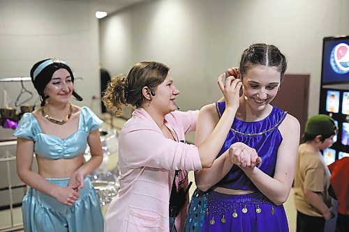 19012023
Mic tech Ava Acevedo helps Amelia Hebert with her mic backstage during the dress rehearsal for DI Productions presentation of Disney Aladdin Jr. at the Western Manitoba Centennial Auditorium on Thursday evening. The musical opens to the public tonight at 7:00PM with shows on Saturday at 7:00PM and Sunday at 2:00PM.
(Tim Smith/The Brandon Sun)