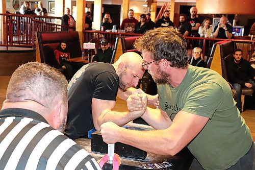 Adam Thompson of Brandon and Matt Schulz of Morris go head-to-head at Houstons Country Roadhouse Saturday afternoon during an official Manitoba Arm Wrestling Association competition. This event featured 37 male and female participants from across the province who competed in six different weight classes. Tournament director Ward Drake told the Sun that Saturday's competition marks the first time MAWA has hosted an event in Brandon in roughly 10 years.  (Kyle Darbyson/The Brandon Sun)
