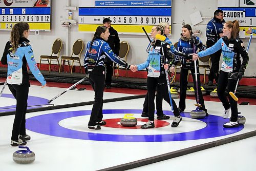Members of Zoey Terrick and Grace Beaudry's teams shake hands after Terrick won the Manitoba provincial junior women's curling champion on Saturday evening in a 9-8 extra end affair at the Portage Curling Club. (Lucas Punkari/The Brandon Sun)