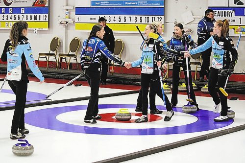Members of Zoey Terrick and Grace Beaudry's teams shake hands after Terrick won the Manitoba provincial junior women's curling champion on Saturday evening in a 9-8 extra end affair at the Portage Curling Club. (Lucas Punkari/The Brandon Sun)