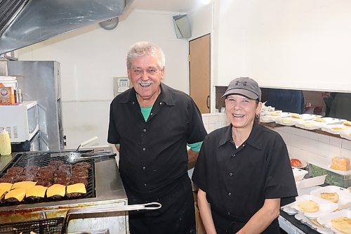 Brian and Christine Kilborn cook up some burgers and fries for a visiting hockey team on Sunday afternoon in Brandon. The father-daughter team serve as the Beef and Barrel Restaurant's owner and manager, respectively, and will be working tirelessly until the business officially closes its doors March 31. (Kyle Darbyson/The Brandon Sun)