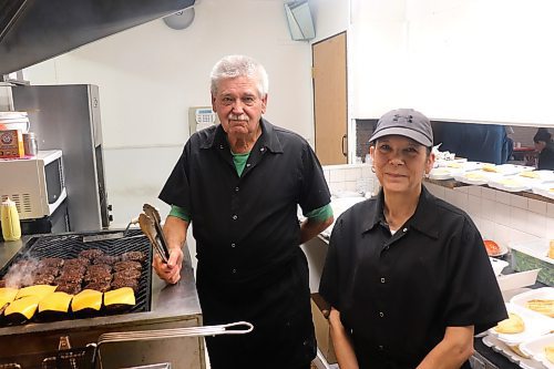 Brian and Christine Kilborn cook up some burgers and fries for a visiting hockey team on Sunday afternoon in Brandon. The father-daughter team serve as the Beef and Barrel Restaurant's owner and manager, respectively, and will be working tirelessly until the business officially shuts its doors March 31. (Kyle Darbyson/The Brandon Sun)