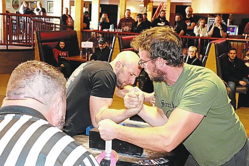 Adam Thompson of Brandon (left) and Matt Schulz of Morris go head-to-head at Houstons Country Roadhouse Saturday afternoon during an official Manitoba Arm Wrestling Association competition. This event featured 37 male and female participants from across the province who competed in six different weight classes. Tournament director Ward Drake told the Sun that Saturday's competition marks the first time MAWA has hosted an event in Brandon in roughly 10 years. See more photos on Page A2. (Kyle Darbyson/The Brandon Sun)