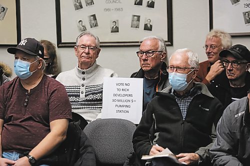 A member of the public holds up a sign opposing the southwest lift station at Monday's public hearing on the project. (Colin Slark/The Brandon Sun)