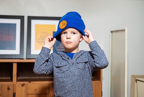 JESSICA LEE / WINNIPEG FREE PRESS

Heather and Sid Barkman&#x2019;s son Arthur, 4, is photographed holding modelling their apparel&#x2019;s toque in their Winnipeg home on January 23, 2023. Their two-year-old venture, Maroons Road Apparel, depicts 10 different iconic Winnipeg images on t-shirts, hoodies and prints.

Reporter: Dave Sanderson