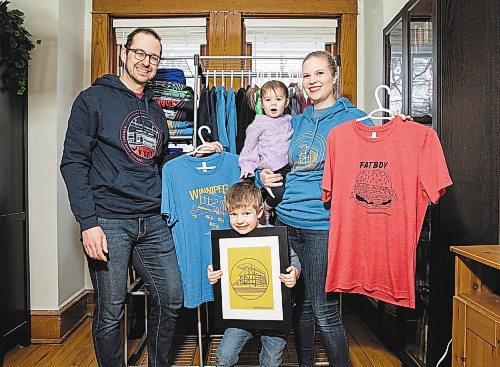 JESSICA LEE / WINNIPEG FREE PRESS

Heather and Sid Barkman and their children Penny, 1, and Arthur, 4, are photographed holding their apparel in their Winnipeg home on January 23, 2023. Their two-year-old venture, Maroons Road Apparel, depicts 10 different iconic Winnipeg images on t-shirts, hoodies and prints.

Reporter: Dave Sanderson