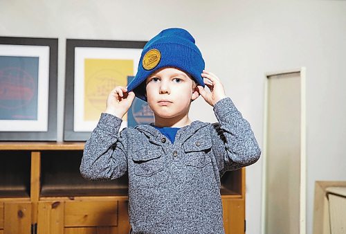 JESSICA LEE / WINNIPEG FREE PRESS

Heather and Sid Barkman&#x2019;s son Arthur, 4, is photographed holding modelling their apparel&#x2019;s toque in their Winnipeg home on January 23, 2023. Their two-year-old venture, Maroons Road Apparel, depicts 10 different iconic Winnipeg images on t-shirts, hoodies and prints.

Reporter: Dave Sanderson