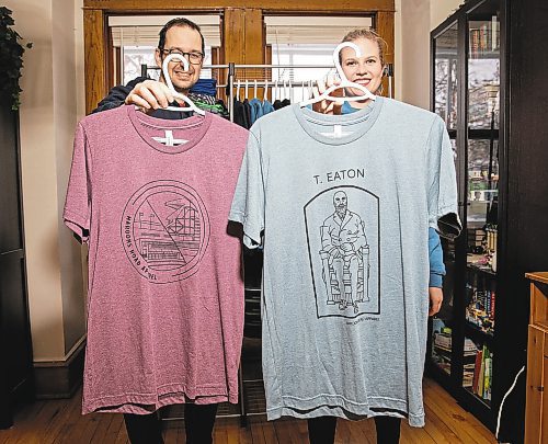 JESSICA LEE / WINNIPEG FREE PRESS

Heather and Sid Barkman are photographed holding their apparel in their Winnipeg home on January 23, 2023. Their two-year-old venture, Maroons Road Apparel, depicts 10 different iconic Winnipeg images on t-shirts, hoodies and prints.

Reporter: Dave Sanderson