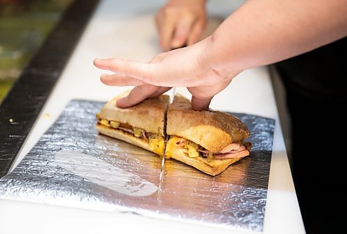 JESSICA LEE / WINNIPEG FREE PRESS

A worker cuts a toasted sandwich at Stonework&#x2019;s Bistro on January 24, 2034. The fast casual eatery located near Winnipeg Square is owned by Chef Mike Publicover.

Reporter: Dave Sanderson